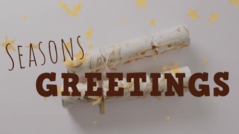 animation of christmas greetings text over christmas crackers