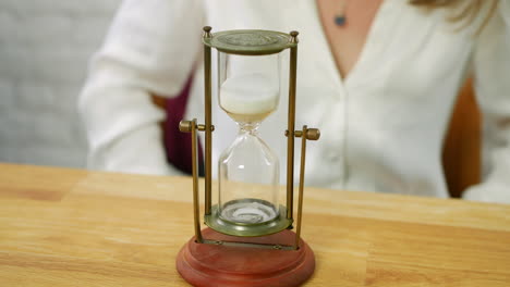 an hour glass being turned over and started measuring time with sand