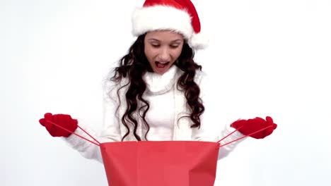 festive brunette opening a gift bag