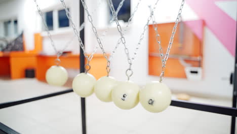 newton's cradle showing laws of physics in motion. museum of science and newton pendulum