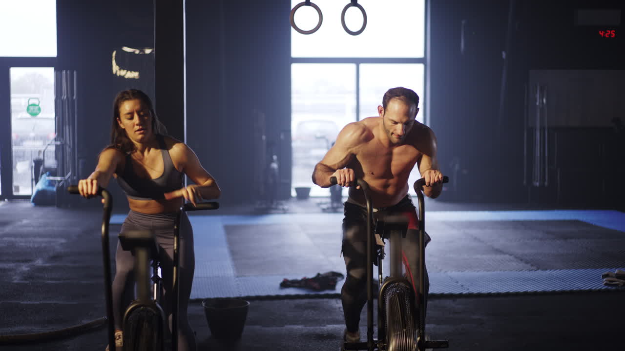 People Working Out on Exercise Bikes in a Gym