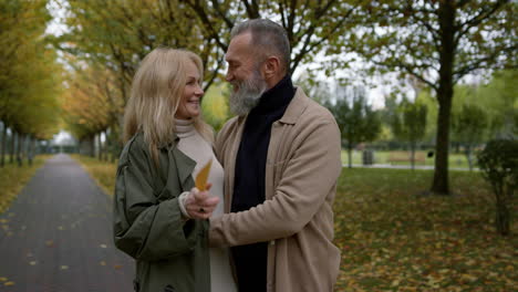 romantic mature couple standing face to face in town park