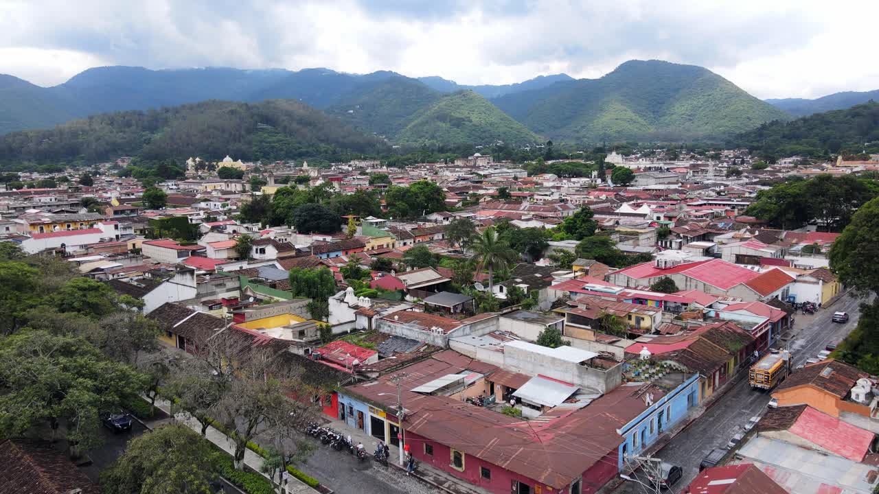 4K aerial drone footage of Antigua, Guatemala, highlighting the city’s colorful buildings and vibrant streets. The scene captures the charming and historic architecture that defines the city