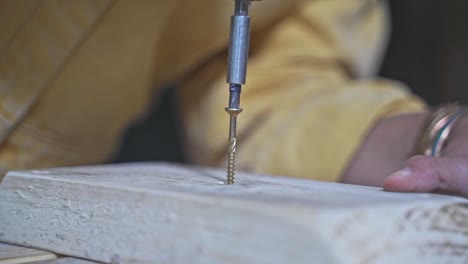 workshop woodworker screwing a screw screwdriver