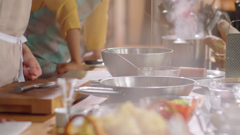 chef pouring oil in pan during cooking master class