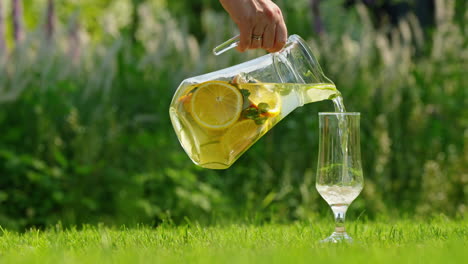 pouring a refreshing fruit-infused beverage