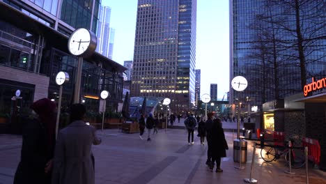 people walking in reuters plaza at dusk. panning pov dutch angle shot.