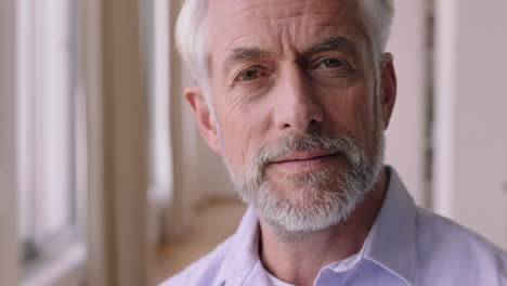 portrait happy old man smiling confident looking out window enjoying retirement lifestyle planning ahead relaxing at home