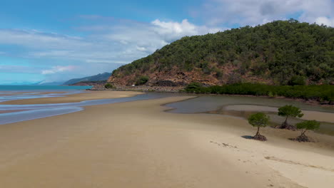 drone shot of tide pools and mountains near port douglas, queensland