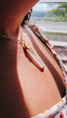 woman wearing a wire-wrapped crystal necklace