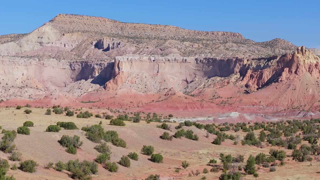 Sweeping view of New Mexico desert landscape with vivid cliffs and blue sky