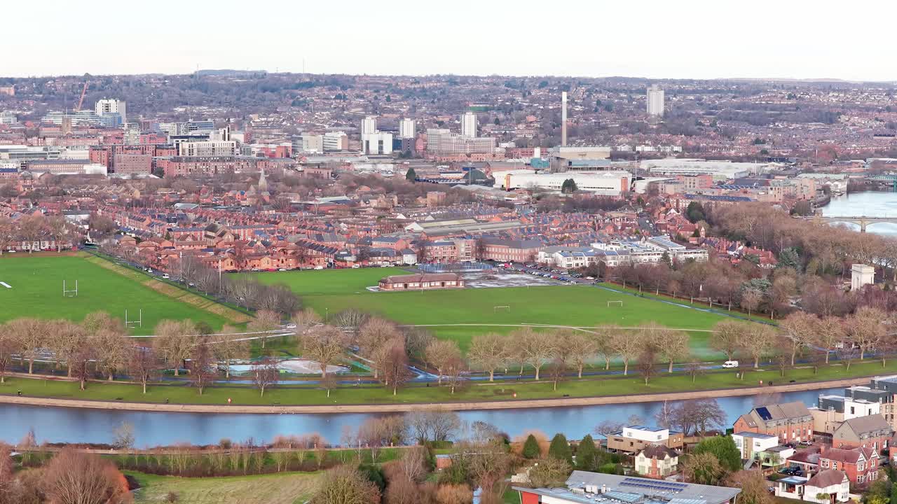 Lady Bay Playing Fields' multiple grass pitches along River Trent in West Bridgford, revealing sports facilities, riverside path, Lady Bay Bridge, and Nottingham city centre skyline, static shot