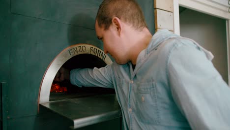 View-of-a-man-adding-firewood-into-the-burning-furnace