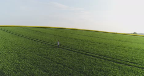 Agriculture-Male-Farmer-Walking-On-Track-Over-Agricultural-Field-While-Using-Digital-Tablet-9