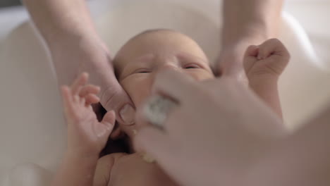 newborn baby crying when bathing