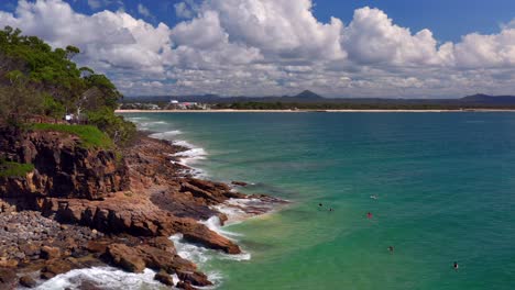 tourist at the rocky beach in noosa national park at boiling pot lookout in coastal walk, noosa heads qld, australia