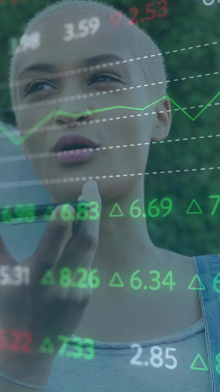 Vertical video: Woman raising phone sharing market charts over her with green red deltas scrolling
