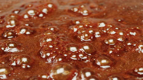 close-up of boiling caramel with bubbles
