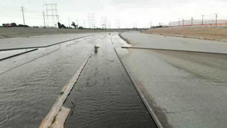 low aerial of dry la river canal with birds