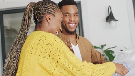 happy african american couple recycling waste