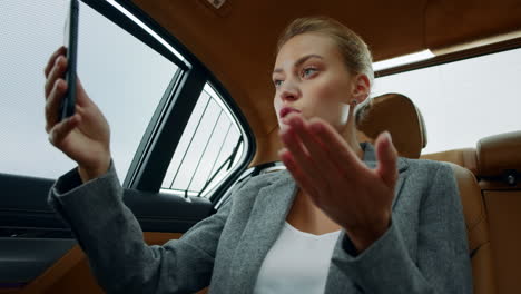 Closeup-focused-business-woman-making-video-chat.-Angry-woman-working-in-car