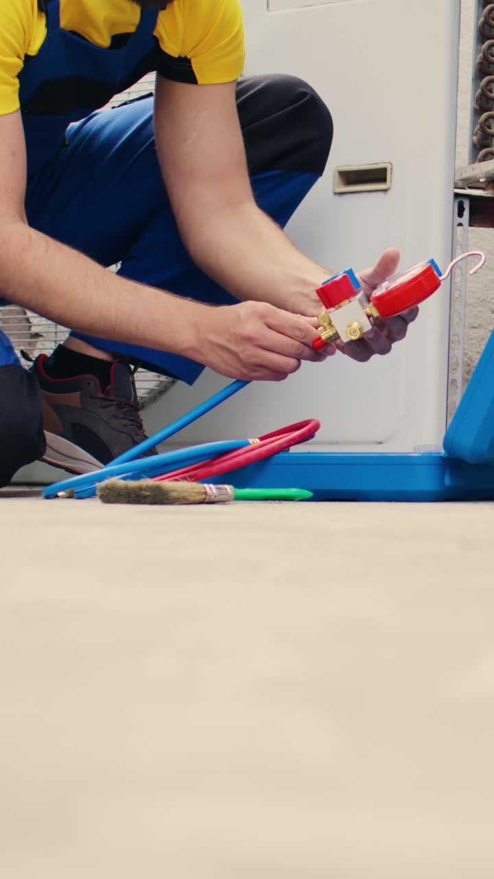 Vertical video Electrician doing hvac system checkup