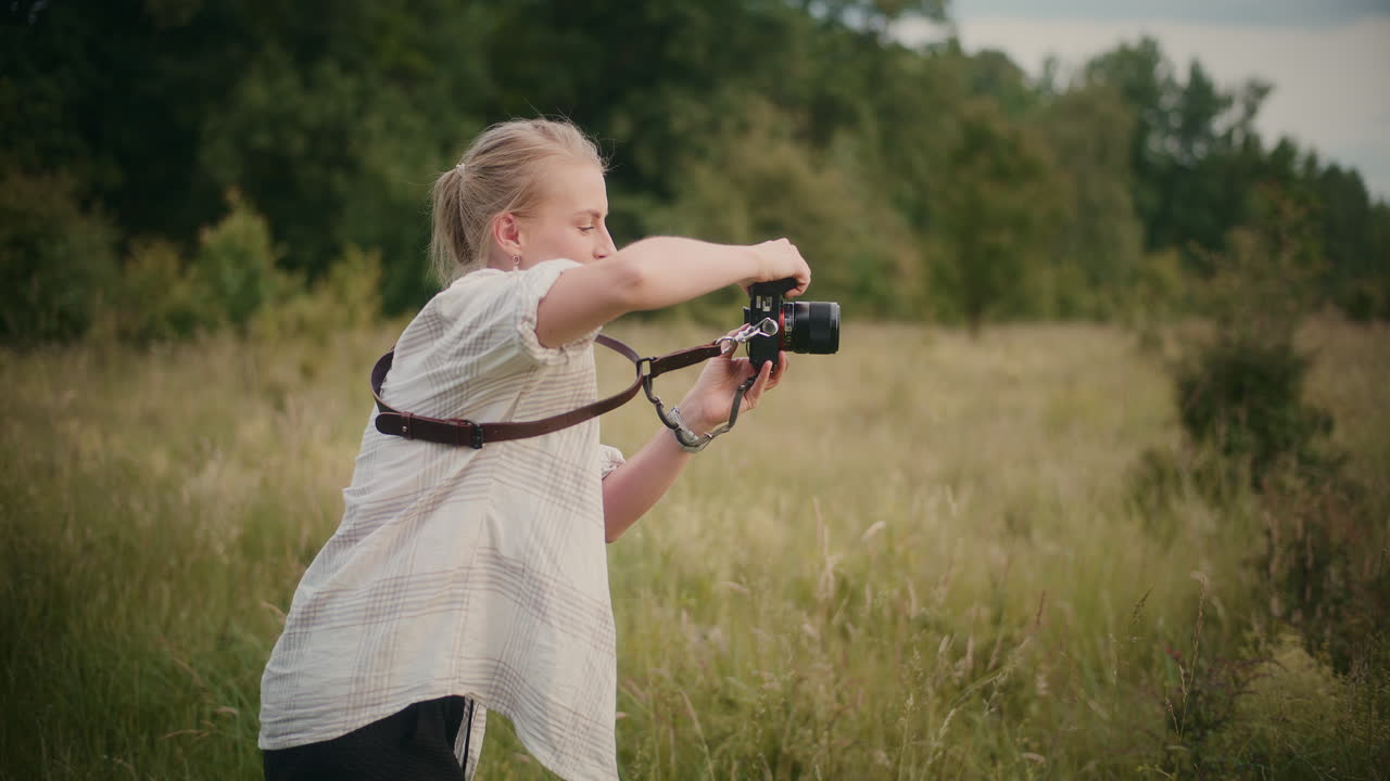 A woman taking pictures in a field