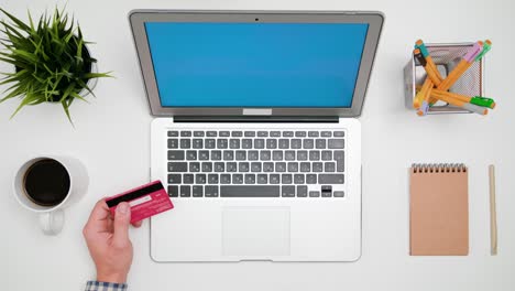 a man's hands typing on the laptop