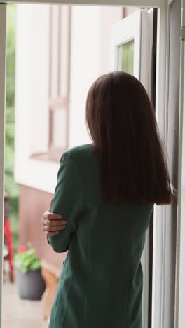 despondent woman gazes at rain through window. woman worker mood darkens watching raindrops trickle down windowpane being lost in depressing thoughts