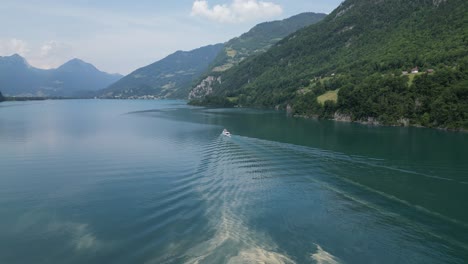 Scenic-boat-ride-in-Switzerland-lake-with-Swiss-Alps-mountain-backdrop