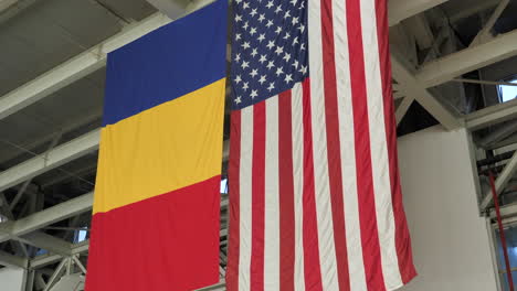 Flags-of-United-States-of-America-and-Romania,-next-to-each-other