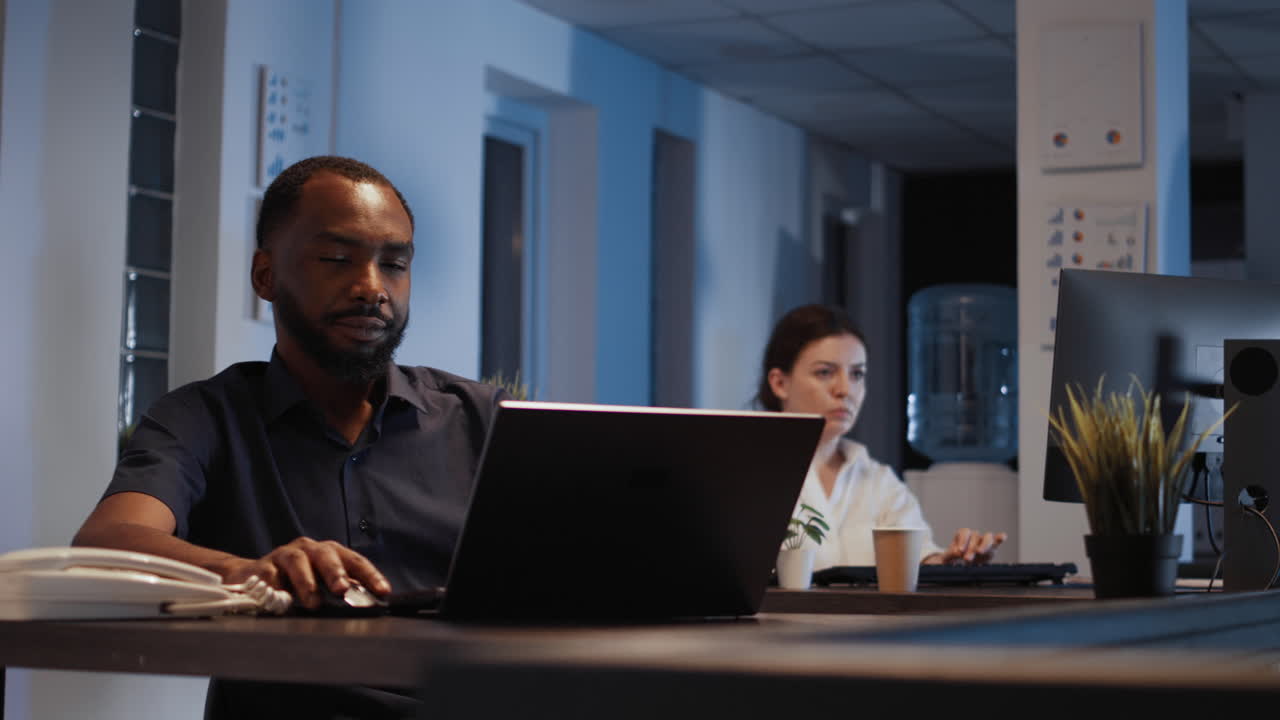 Portrait of disruptive smiling CEO browsing internet on laptop