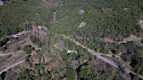 Winding-roads-through-lush-green-forests-in-the-tavertet-region-near-barcelona,-aerial-view