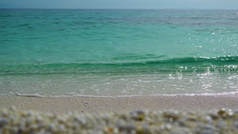 marble beach with vivid crystal clear water, clear blue sky in the background, white sandy beach, thassos island, greece