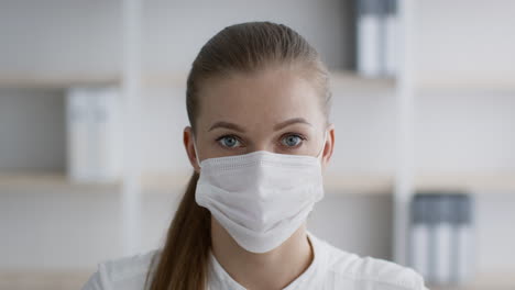 woman wearing a face mask in an office