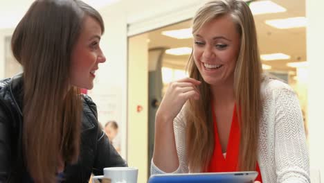 happy friends having coffee together using tablet