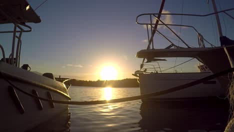 sunset in a bay near two boats in a harbor in the dominican republic