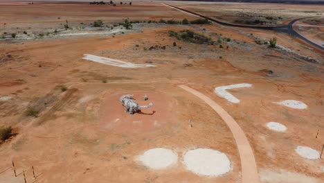 aerial view of a dinosaur statue in a park in the australian outback