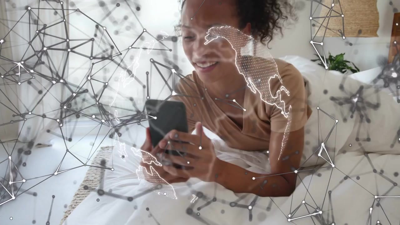 Woman raising smartphone on bed and activating animated tech network overlay, connecting globally