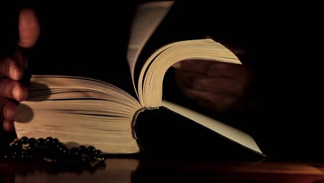 hombre rezando a dios con las manos junto con la biblia hombre caribeño rezando con fondo negro almacen de video