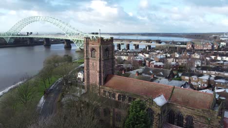 aerial view industrial small town frosty church rooftops neighbourhood north west jubilee bridge england pull back