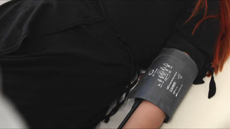 close-up of doctor checking patient's blood pressure using a sphygmomanometer