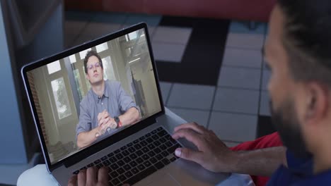 Middle-eastern-man-having-a-video-call-with-male-office-colleague-on-laptop