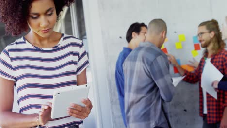 Woman-using-digital-tablet-with-her-colleagues-in-background-4k