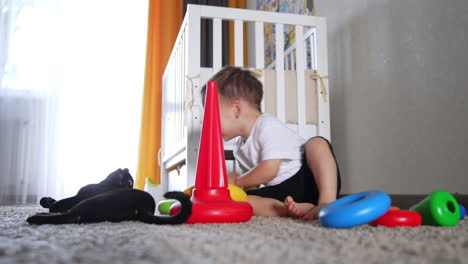 baby playing with toys in a nursery