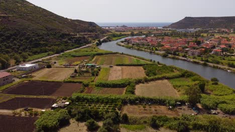 Countryside-of-Bosa-aerial-flying-next-to-river-Temo,-Sardinia,-forward,-day