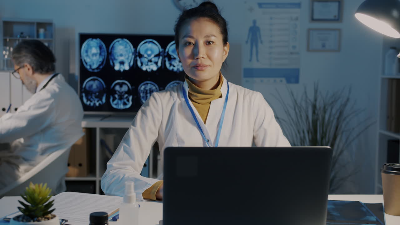 Female Doctor Working on Laptop in Medical Office