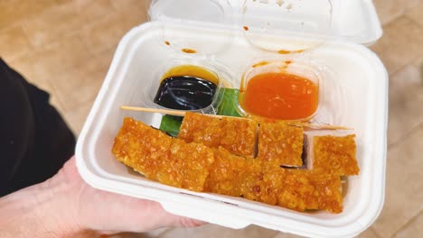 crispy pork belly in disposable container