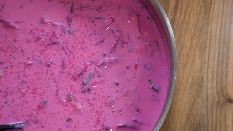 delicious cold beetroot soup in top-down pan view