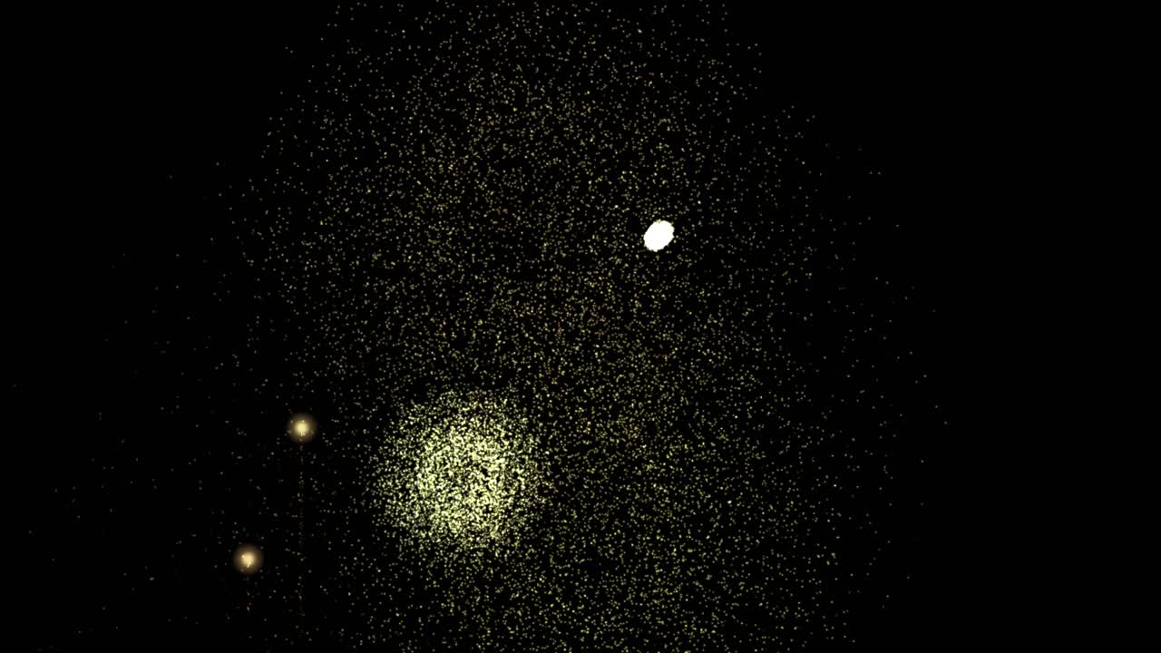 Esplosioni di particelle dorate si propagano e svaniscono su uno sfondo nero in un'animazione celebrativa